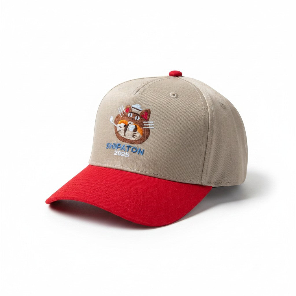 The RevenueCat Swag Store khaki and red structured baseball cap with Shipaton 2025 cat embroidery
