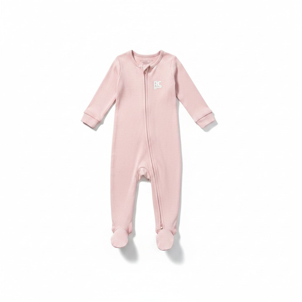 The RevenueCat Swag Store blush pink infant footed one-piece pajama with a front zipper and chest logo.