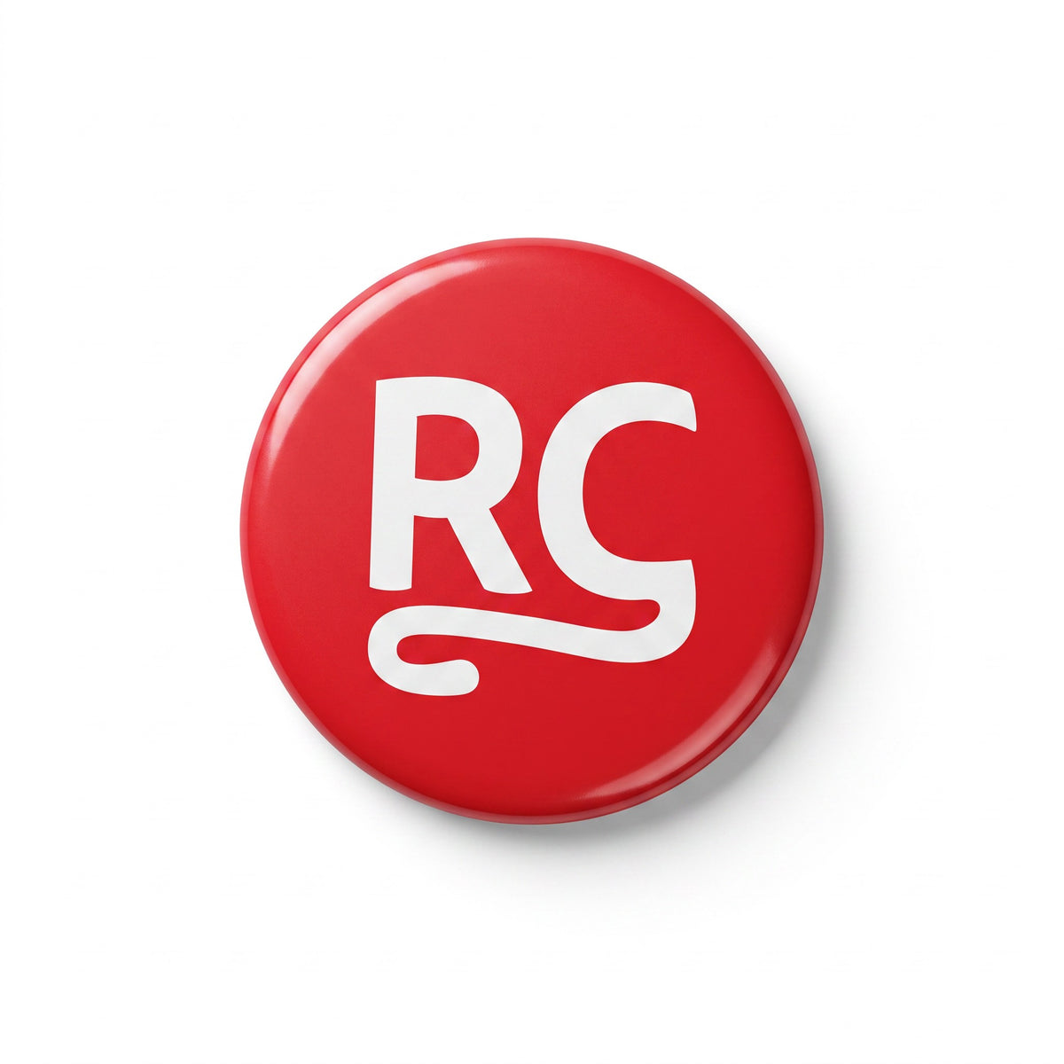 The RevenueCat Swag Store red circular pinback button with a white RC logo on a white background.
